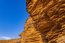 Cliff Of Sedimentary Rocks Against The Blue Sky