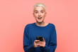 © luismolinero - Teenager girl with white short hair over pink wall surprised and sending a message