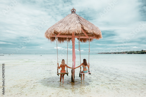 Cuadros en Lienzo Girl on beach swing on Bali island