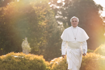 Pope walks at the end of the day in the garden      