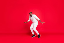 Full Size Photo Of Funny Dark Skin Man Prowl Like Bandit At Night Making Newyear Surprise For Girlfriend Going Slowly Tiptoe Wear Knitted Sweater Trousers Isolated Red Background