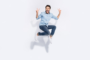 Wall Mural - Full length photo of wild multiethnic guy jumping high yelling loud showing v-sign symbols wear casual denim clothes isolated white color background