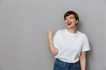 Poster - Image of alluring brunette woman pointing finger aside at copyspace