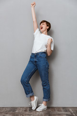 Sticker - Full length image of young woman screaming and gesturing as winner