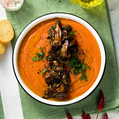 Wall Mural - cream soup of red lentils with tomatoes and fried wild mushrooms on the table. healthy vegan warming food for the whole family