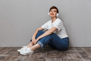 Poster - Image of gorgeous woman listening to music with headphones on floor