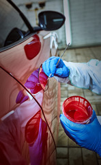 Wall Mural - Tinting defects of a red car paint on the service