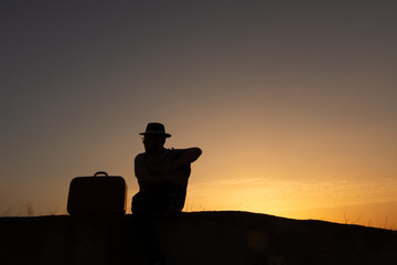 Sticker - silhouette of man with suitcase at sunrise