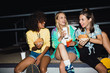 © Drobot Dean - Image of skater girls eating fastfood and drinking soda at night