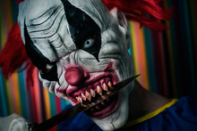 Scary Evil Clown With A Knife In His Mouth