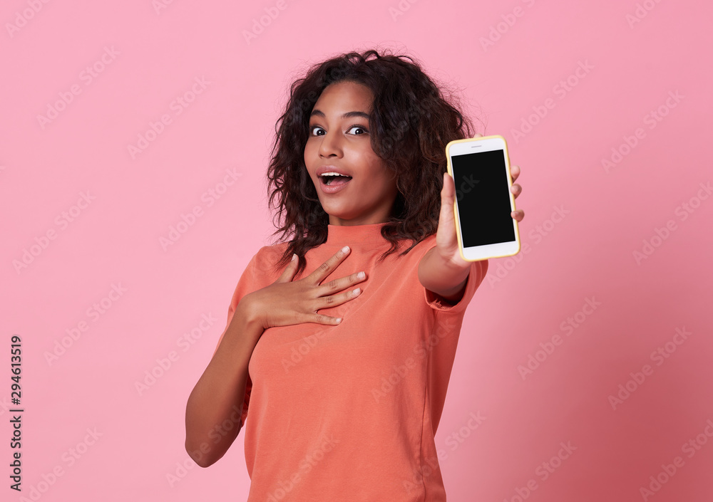 Portrait of a excited young african woman showing at blank screen ...