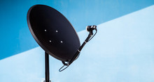 Black Satellite Dish On A Blue Background. Satellite Dish For Frequency KU-band