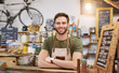 © marvent - Friendly young entrepreneur standing behind the counter of his cafe