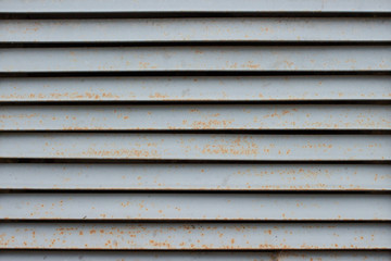 Abstract metal horizontal jalousie partitions with rust background