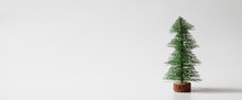 Web Banner Miniature Christmas Tree On White Background With Copy Space For Text. Winter Holiday Celebration Concept.