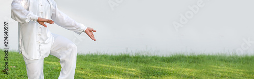 Asian man working out with Tai Chi in the morning at the park, Chinese martial arts, healthy care for life concept Фотошпалери