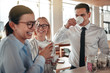 © Flamingo Images - Young businesspeople laughing together during their office coffe