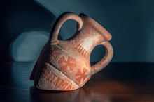 Broken Old Amphora On A Wooden Background