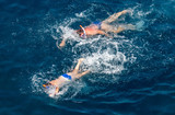 Fototapeta Łazienka - People swim in the blue water of the sea