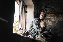 Man Hugging Dirty Kid Near German Shepherd Dog In Abandoned Building, Post Apocalyptic Concept