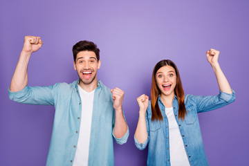 Poster - Portrait of romantic crazy content lucky spouses raise fists scream yeah celebrate victory in competition wear trendy clothes isolated over purple violet color background