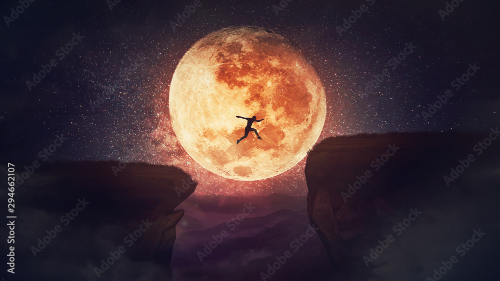 Surreal scene, self overcome concept, as determined man jump over a chasm obstacle. Way to win and success over starry night with full moon background. Motivation for achieving goals. - obrazy, fototapety, plakaty 
