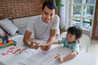 toddler learning math and counting with her father at home together