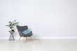© New Africa - Stylish room interior with comfortable armchair and plant near white wall. Space for text
