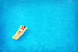 © New Africa - Young woman on inflatable mattress in swimming pool, above view