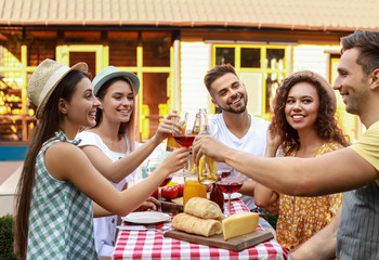 Canvas Print - Happy friends with drinks having fun at barbecue party outdoors