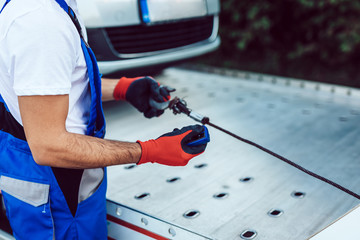 Wall Mural - Handsome middle age man working in towing service on the road. Roadside assistance concept.