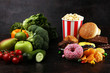 healthy or unhealthy food. Concept photo of healthy and unhealthy food. Fruits and vegetables vs donuts and fast food