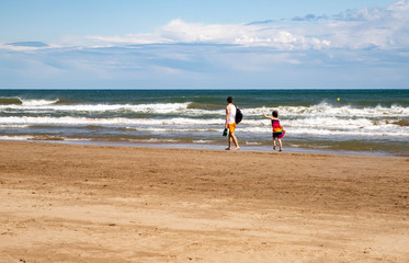 man and child by the sea