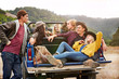 © Trinette Reed/Stocksy - Portrait of group of friends in nature while on road trip relaxing