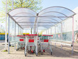 © Lawren Lu/Stocksy - Supermarket shopping trolleys under awning in spring sunshine