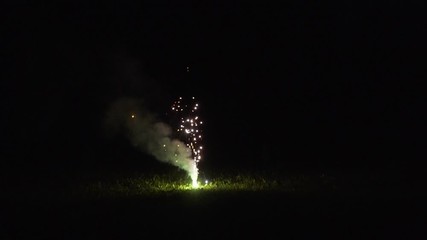 Wall Mural - Spark pyrotechnics sparkling fountain standing on the ground. Slow motion footage.