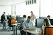 © Lumina/Stocksy - Businesspeople Working at Open Space Office