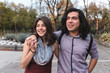 © Manu Prats/Stocksy - Ethnic couple walking giving a hug each other in park