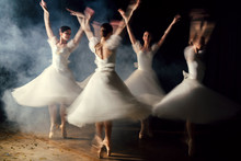 Ballerinas In Dresses Whirling On Scene In Darkness In Fog