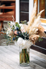 Wall Mural - Wedding bouquet with peonies, succulents and eucalyptus in a glass vase