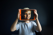Boy With Digital Tablet In Front Of Face