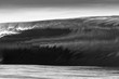 © Cavan Images - A huge and powerful wave breaking in Tahiti black and white shot