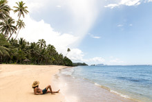 Man, Wearing Straw Hat, Tanning On Golden Sandy Beach, Samoa