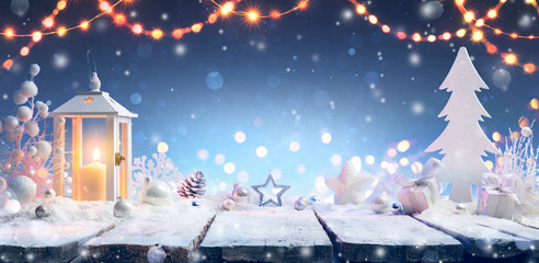 christmas - lantern and gift on snowy table