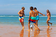 © Sergey Novikov - Children play soccer on the sand beach near water