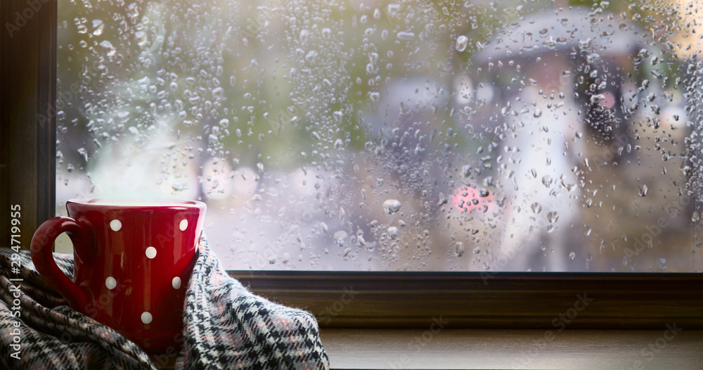 Autumn season background, red cup with hot drink and wet autumnal window - obrazy, fototapety, plakaty 