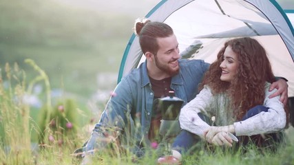 Wall Mural - young tourist couple travellers with tent shelter sitting in nature, resting.