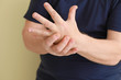 © Pixel-Shot - Senior man suffering from pain in wrist on light background, closeup