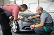 © romul014 - Mechanics in the workshop, talking about car repair,stock photo