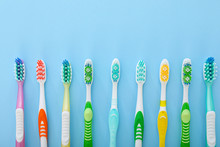 Many Tooth Brushes On Color Background